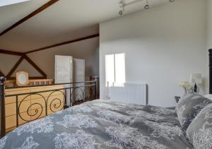 a bedroom with a large bed and a window at Hawthorn Cottage in Barbrook