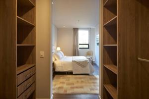 a bedroom with a bed and a room with a closet at Caluce Apt 2B by Letoh in Chía
