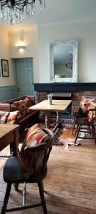 a living room with a table and a couch at The Cricketers Inn in Petersfield