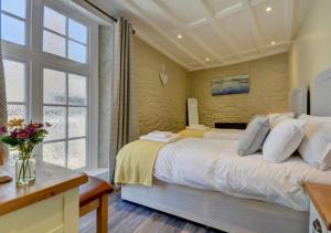 a bedroom with a large bed and a window at Hideaway in Appledore