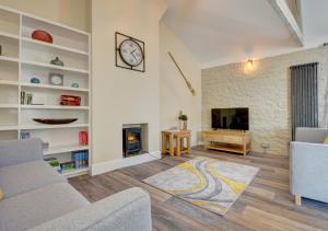 a living room with a couch and a fireplace at Hideaway in Appledore