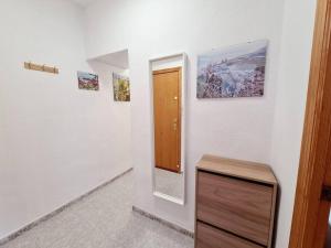a room with a door and paintings on the wall at Comfy Apartment With a Castle View in Cullera