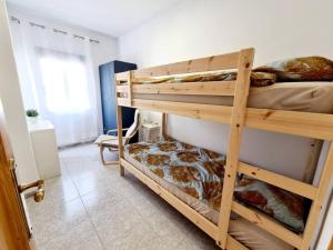 a couple of bunk beds in a room at Comfy Apartment With a Castle View in Cullera