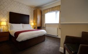a hotel room with a bed and a window at Park View Guest House in Bridlington