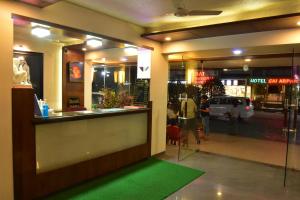 a store front with a green mat in front of a window at Hotel Dhantara in Shirdi