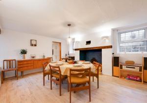 a kitchen and dining room with a table and chairs at Kimblewick in Braunton