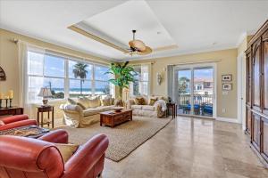 a living room with couches and a ceiling fan at Ocean Vue By Beachside Management in Siesta Key