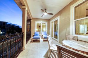 a balcony with blue chairs and a balconyvisorvisor at Ocean Vue By Beachside Management in Siesta Key