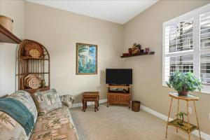 a living room with a couch and a flat screen tv at Ocean Vue By Beachside Management in Siesta Key