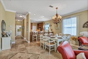 a dining room and kitchen with a table and chairs at Ocean Vue By Beachside Management in Siesta Key