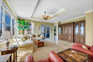 a living room with furniture and a ceiling fan at Ocean Vue By Beachside Management in Siesta Key