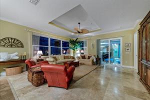 a living room with red chairs and a couch at Ocean Vue By Beachside Management in Siesta Key