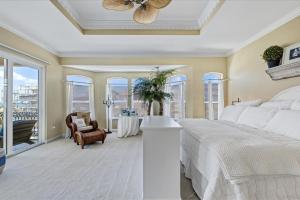 a bedroom with a bed and a table and chairs at Ocean Vue By Beachside Management in Siesta Key