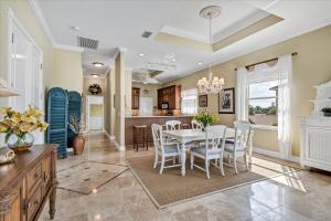 a dining room and kitchen with a table and chairs at Ocean Vue By Beachside Management in Siesta Key