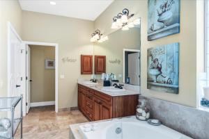 a bathroom with two sinks and a large mirror at Ocean Vue By Beachside Management in Siesta Key