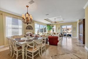 a dining room and living room with a table and chairs at Ocean Vue By Beachside Management in Siesta Key