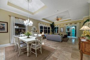 a dining room and living room with a table and chairs at Ocean Vue By Beachside Management in Siesta Key