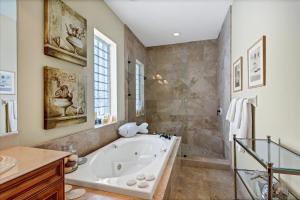 a large bathroom with a tub and a shower at Ocean Vue By Beachside Management in Siesta Key