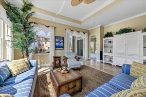 a living room with a blue couch and a table at Ocean Vue By Beachside Management in Siesta Key +37 photos