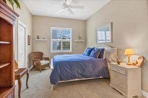 a bedroom with a bed and a ceiling fan at Ocean Vue By Beachside Management in Siesta Key