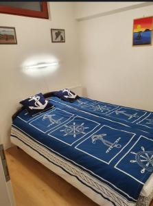 a bed with a blue blanket with bicycles on it at Lido Dalma Apartman 2 in Fonyód