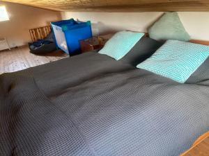 a large bed with two pillows on top of it at Ferienhaus Scandia am See in Warnitz