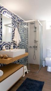 a bathroom with a sink and a shower at Merastri Villa in Zaros