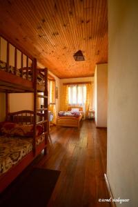 a bedroom with two bunk beds and a wooden ceiling at An-tsaha Chambre d'hôtes in Fianarantsoa