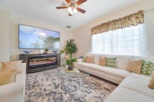 a living room with a white couch and a fireplace at VILLA AWESOME! in Cape Coral