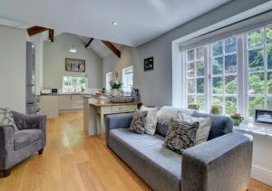 a living room with a couch and a kitchen at Mariners in Barbrook