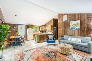 a living room with a couch and chairs and a kitchen at Modern w Fire Pit Deck, Grill & Hot Tub in Berkeley Springs