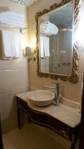 a bathroom with a sink and a mirror at Golden Marmara Hotel in Istanbul