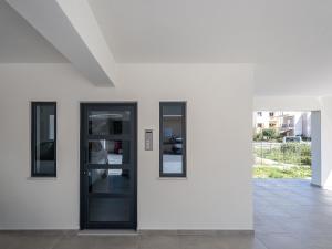 a white wall with three mirrors on it at Mossa City Apartments in Chania Town