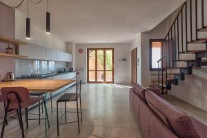 a kitchen and living room with a couch and a table at Bellaria Rooms in Montalcino