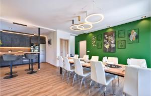 a dining room with a long table and white chairs at Stunning Home In Stubicke Toplice With Outdoor Swimming Pool, Heated Swimming Pool And Sauna in Stubicke Toplice
