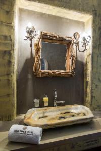 a bathroom with a stone sink and a mirror at Deluxe Paros Villa Grand Villa Sea View Private Pool 4 BDR Tserdakia in Kampos Paros
