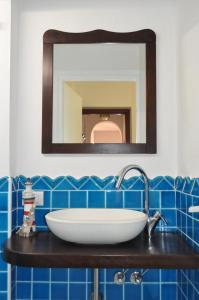 a bathroom with a sink and a mirror at Villa Hibisco in San Vito lo Capo