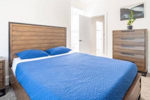 a bedroom with a blue bed with a wooden headboard at Entire Home in Newport in Newport