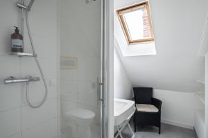 a bathroom with a shower and a toilet and a sink at Villa Sainte Geneviève in Saint Malo +16 photos
