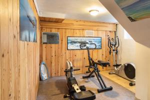 a gym with wood paneling and exercise equipment at Villa Sainte Geneviève in Saint Malo