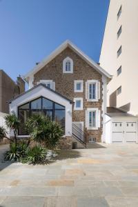 a brick house with large windows and a building at Villa Sainte Geneviève in Saint Malo