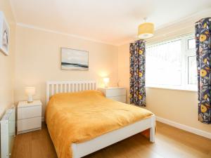 a bedroom with a bed and a window at 8 Royal Chalet Park in Norwich