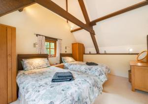 Meshaw的住宿－Meadowside Barn，阁楼上的卧室配有两张床