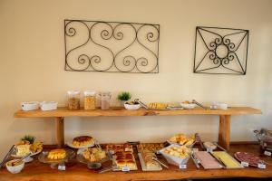 uma mesa cheia de diferentes tipos de alimentos em Hotel Dona Paschoalina em Socorro