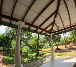 a pavilion with a view of a park at Leon Hilltop Resort in Kitulgala