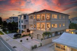 a large house with a sunset in the background at Ocean Vue in Siesta Key