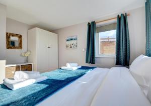 a bedroom with a large bed with two towels on it at Ocean Villa in Woolacombe