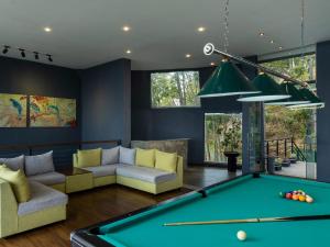 a living room with a pool table at GreenAcres Leisure Resort in Kandy