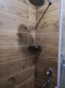 a shower with a glass door in a bathroom at Стильная квартирка у моря in Batumi