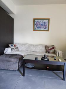 a living room with a couch and a table at Pegasus cosy house in Athens